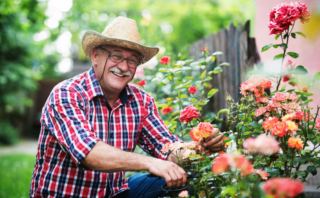 Buda Oaks | Senior gardening in cowboy hat