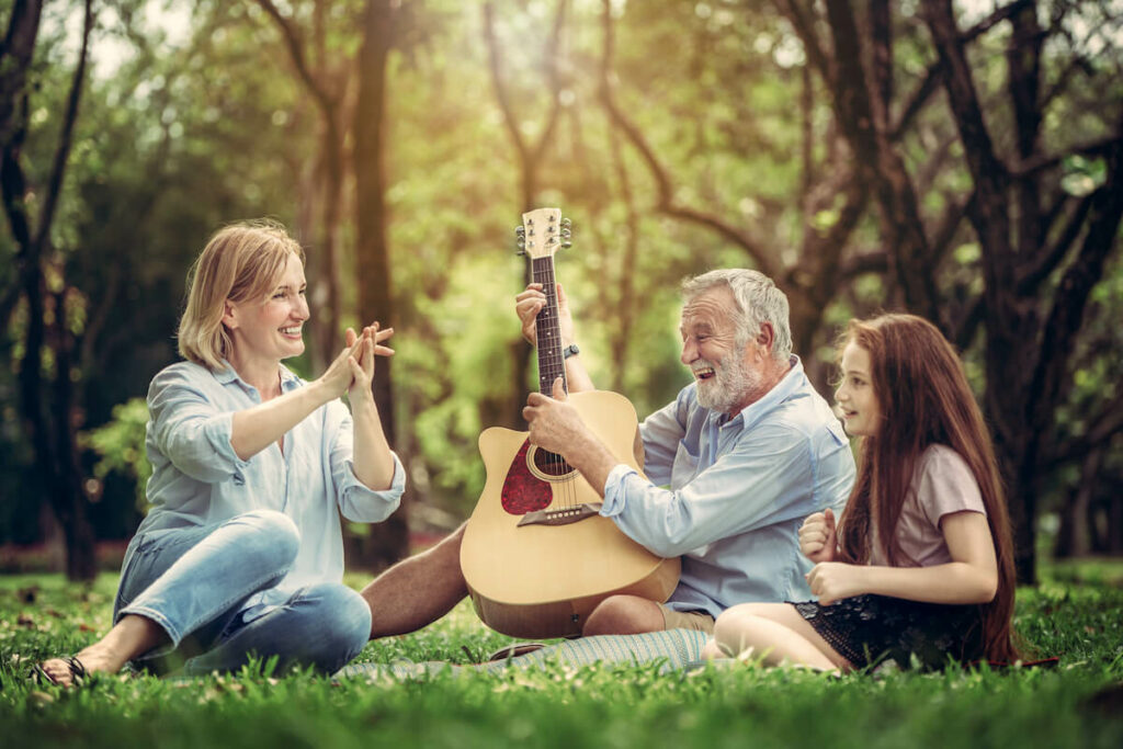 Buda Oaks | Senior playing guitar for his daughter and granddaughter