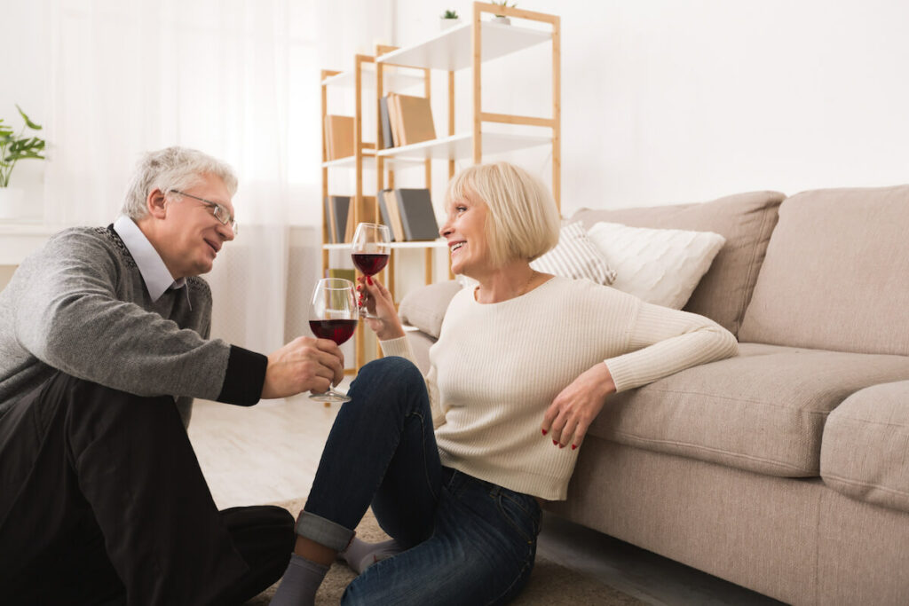 Buda Oaks | Senior couple sitting on the floor having a glass of wine