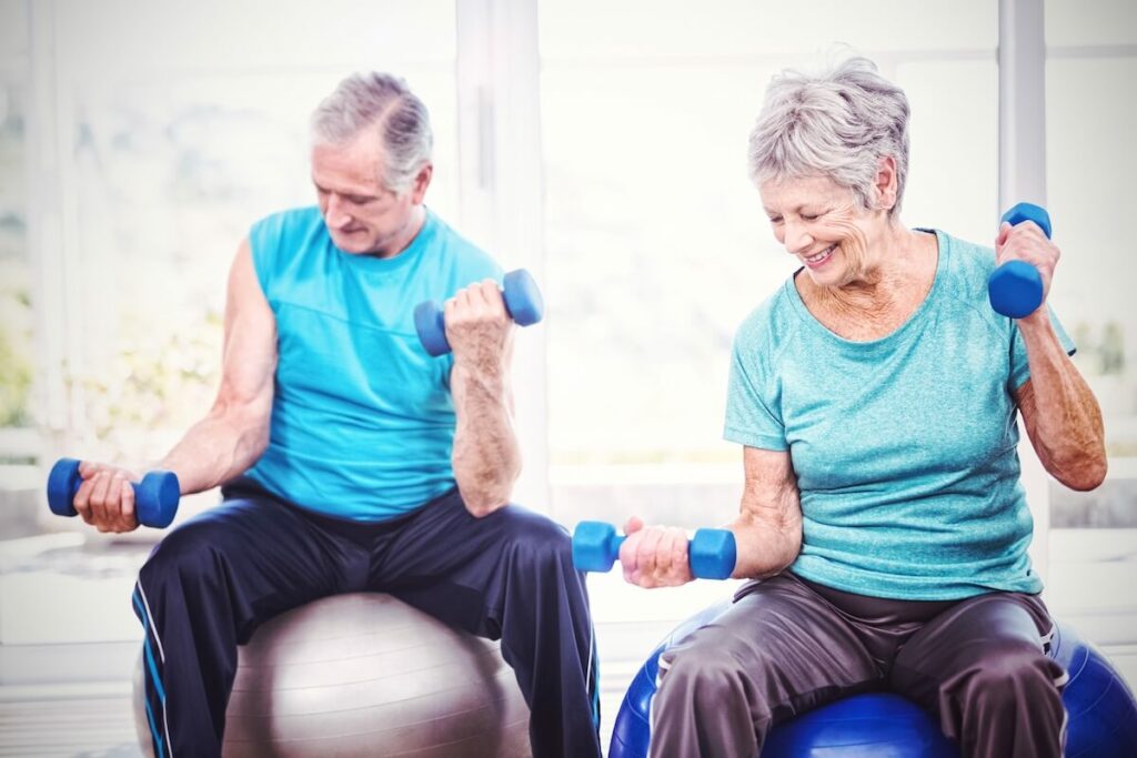 Buda Oaks | A couple of seniors doing strength exercises with workout balls and small weights