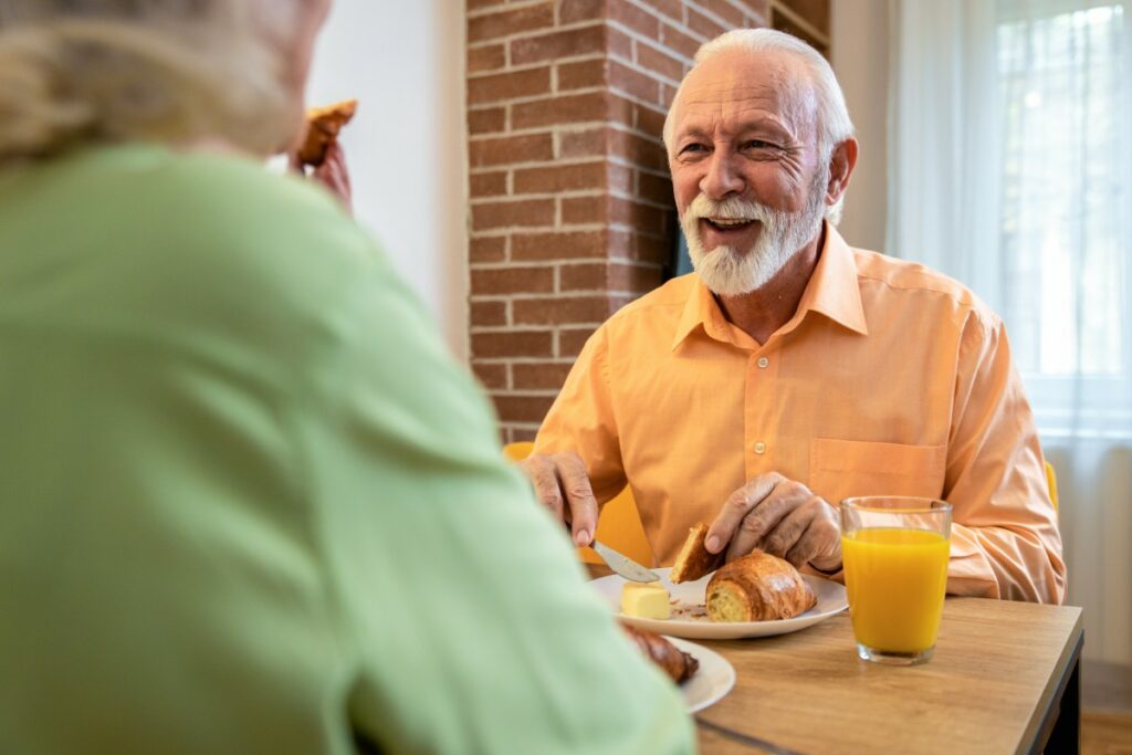 Buda Oaks | Senior man eating breakfast in apartment