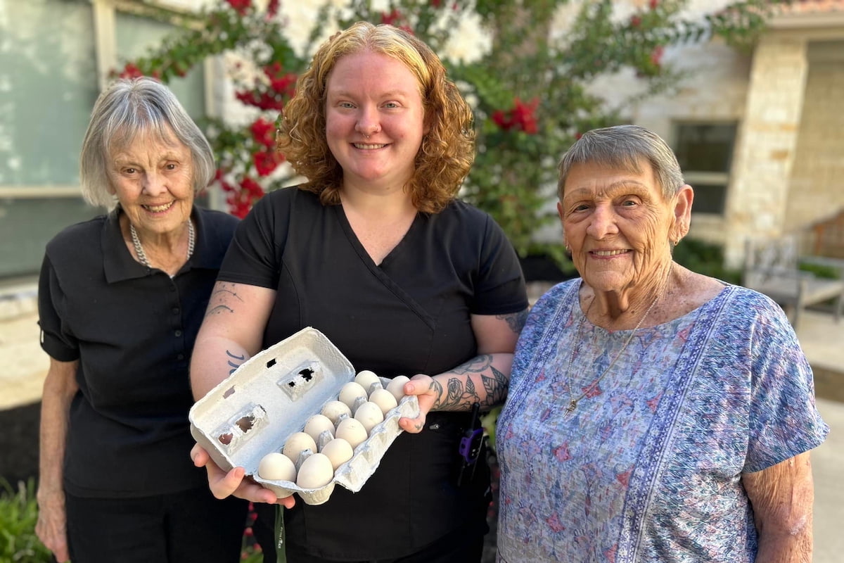 Buda Oaks | Senior resident and caretakers collecting fresh eggs