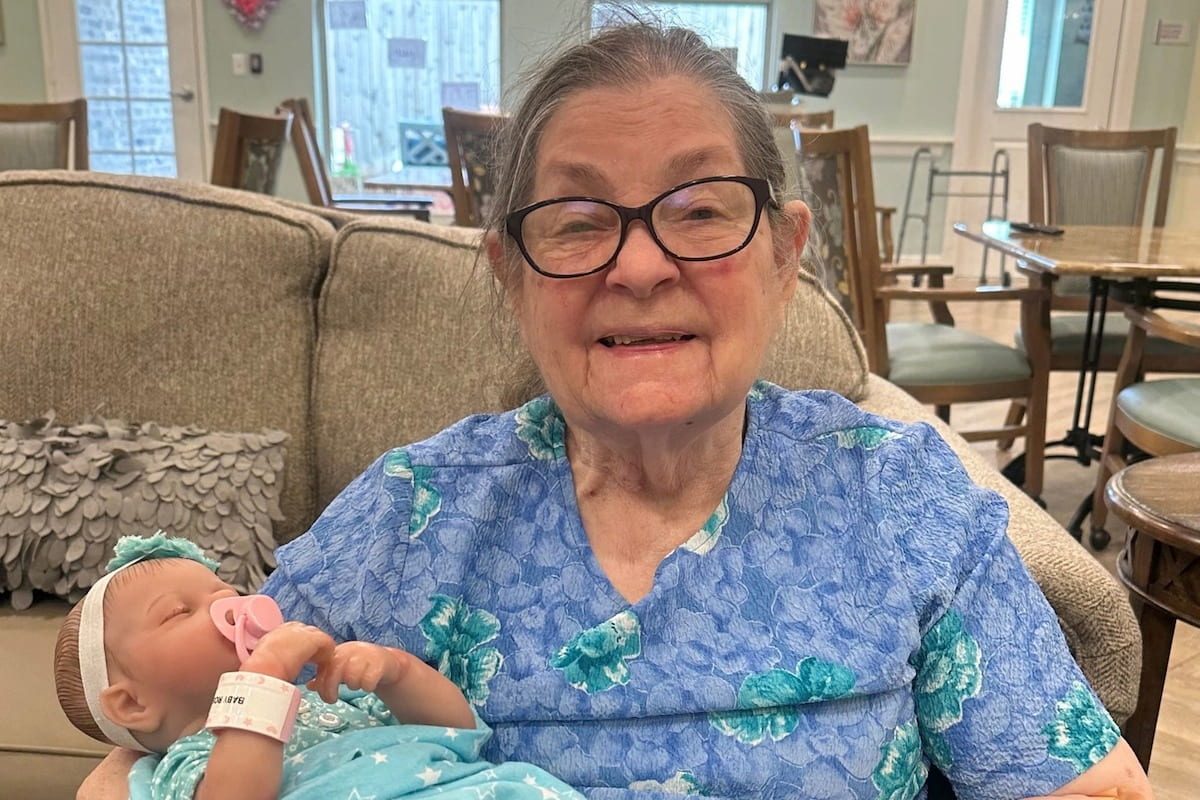 Buda Oaks | Senior woman doing doll therapy