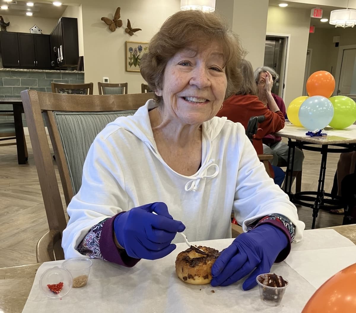 Buda Oaks | Senior resident making a donut